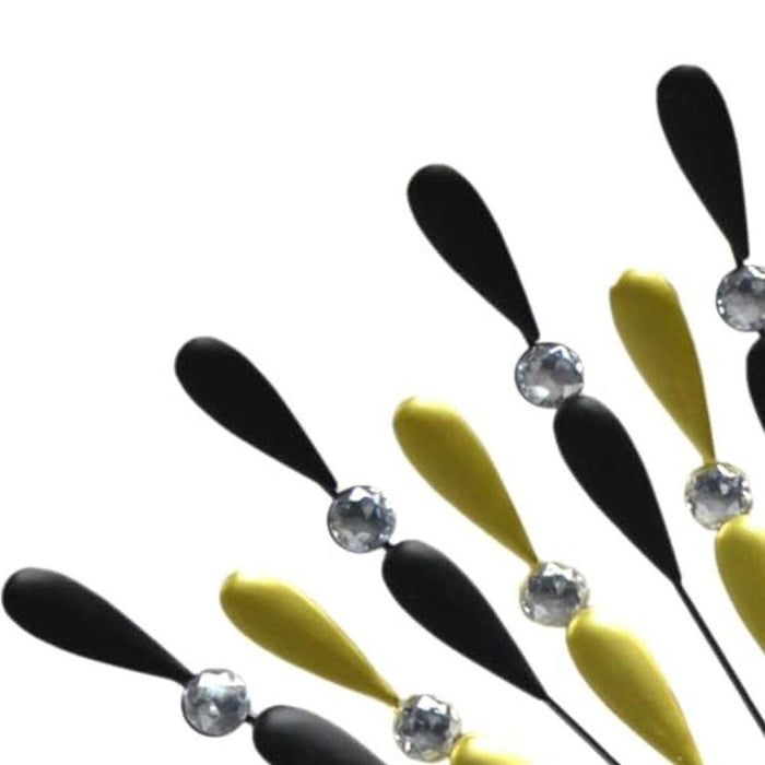 Black and yellow hair clips with crystal embellishments on a white background