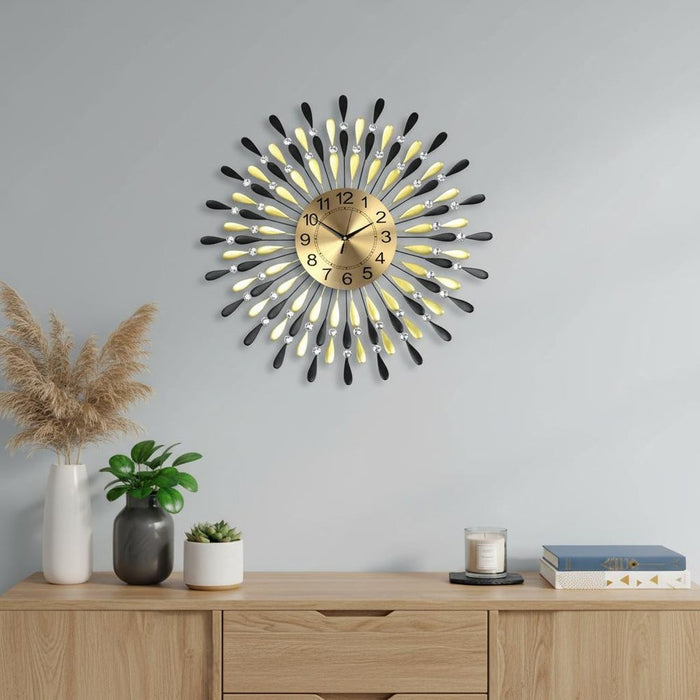 Decorative wall clock with illuminated hands on a gray wall above a wooden console table.