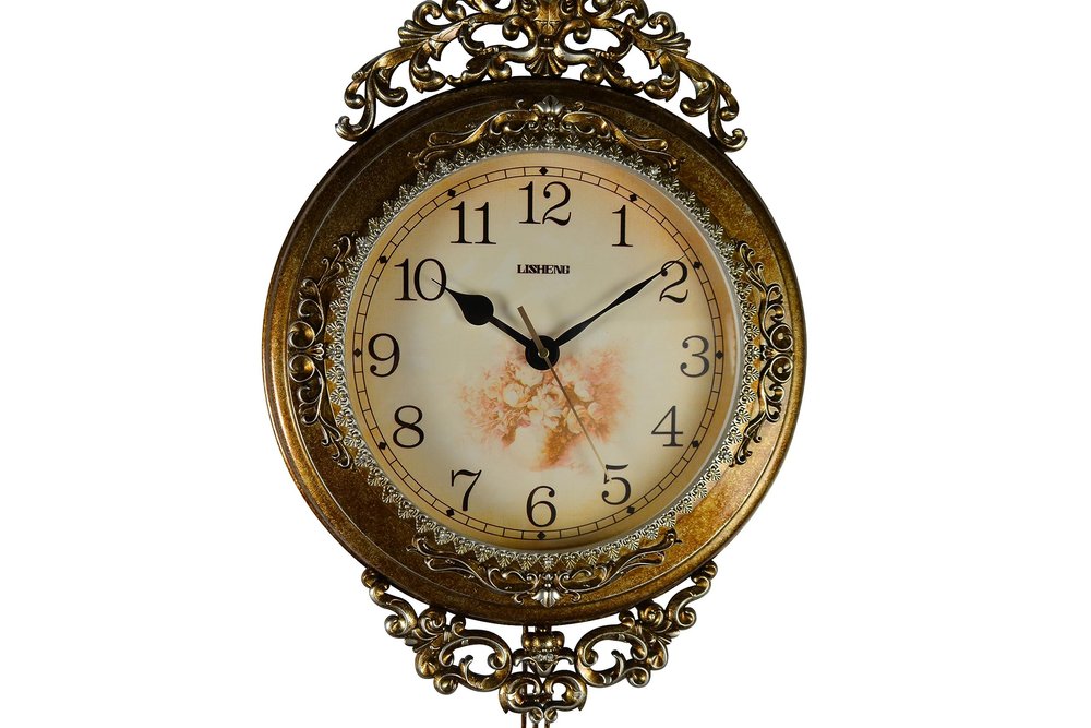 Decorative wall clock with intricate design on a white background
