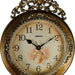 Decorative clock with floral design and ornate gold frame on a white background