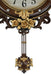 Decorative wall clock with floral design and pendulum on a white background