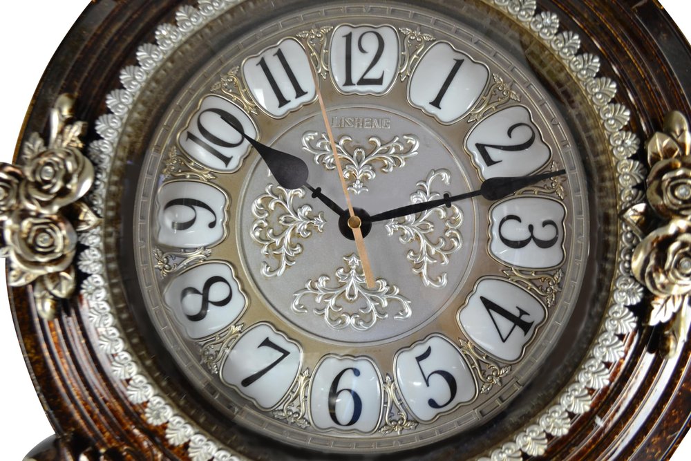 Decorative clock with floral designs on a white background