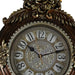 Decorative clock with intricate design and gold accents on a white background