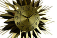 Gold sunburst clock with black numbers on a white background