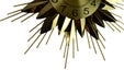 Gold sunburst clock with black numbers on a white background
