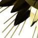 Gold and black decorative object with pointed ends on a white background