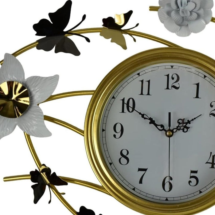 Decorative wall clock with gold frame, flowers, and butterflies on a white background