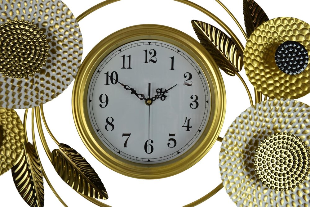 Decorative wall clock with gold floral designs on a white background