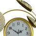 Gold-framed clock with decorative elements on a white background