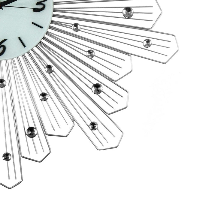 Decorative wall clock with a sunburst design on a white background
