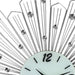 Decorative wall clock with sunburst design and crystal accents