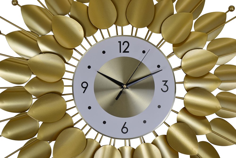 Decorative wall clock with gold leaf-like design on a white background