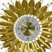 Decorative wall clock with gold leaf-like design on a white background