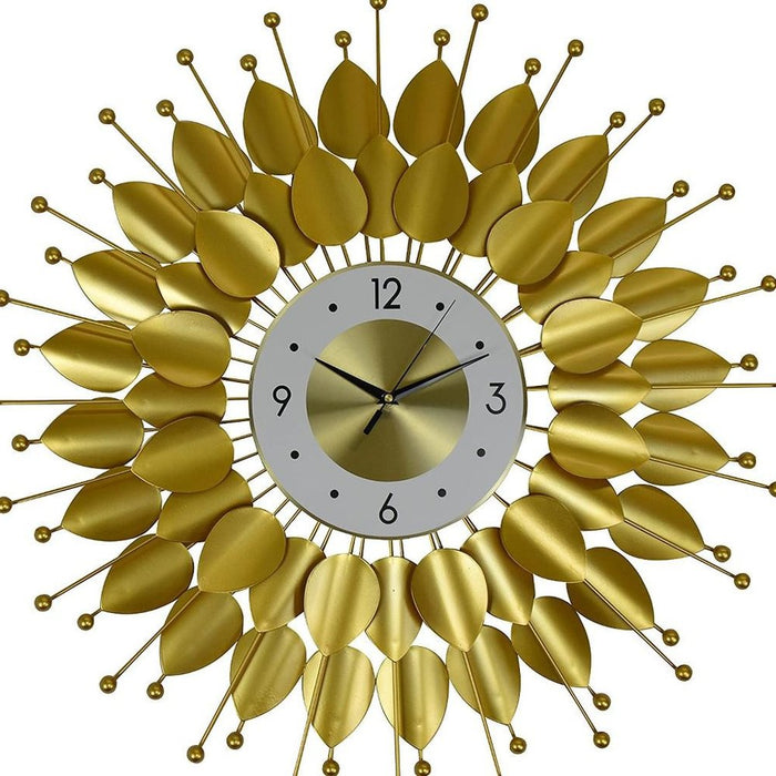 Decorative wall clock with gold leaf-like design on a white background