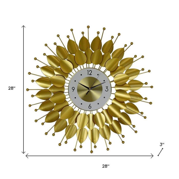 Gold leaf-patterned wall clock with measurements on a white background