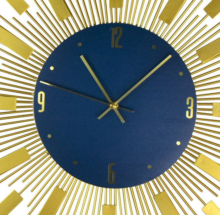 Wall clock with blue face and gold accents on a white background