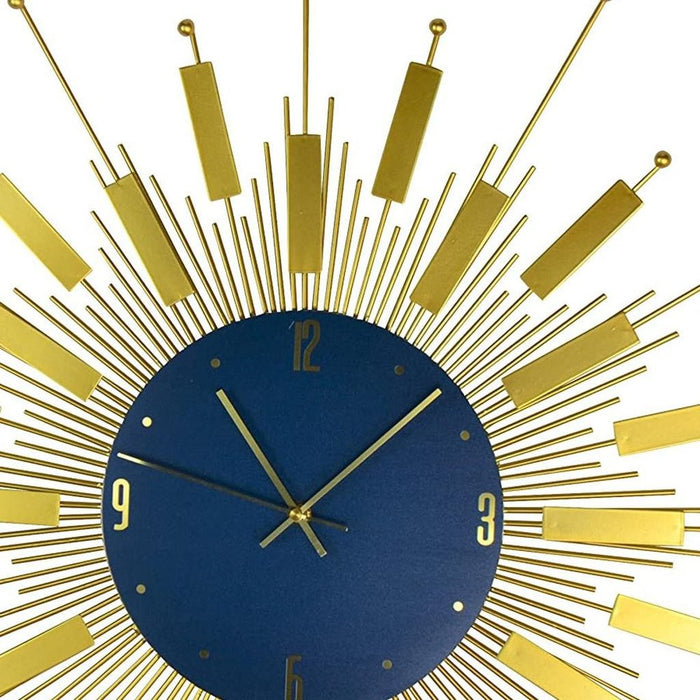 Decorative wall clock with gold sunburst design and blue center