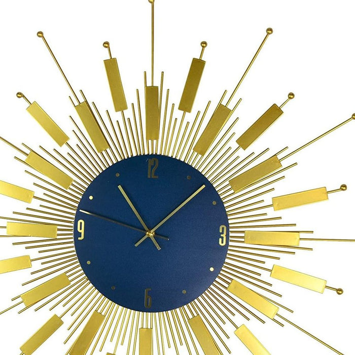 Decorative wall clock with a gold design on a blue face