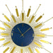 Decorative wall clock with a gold design on a blue face
