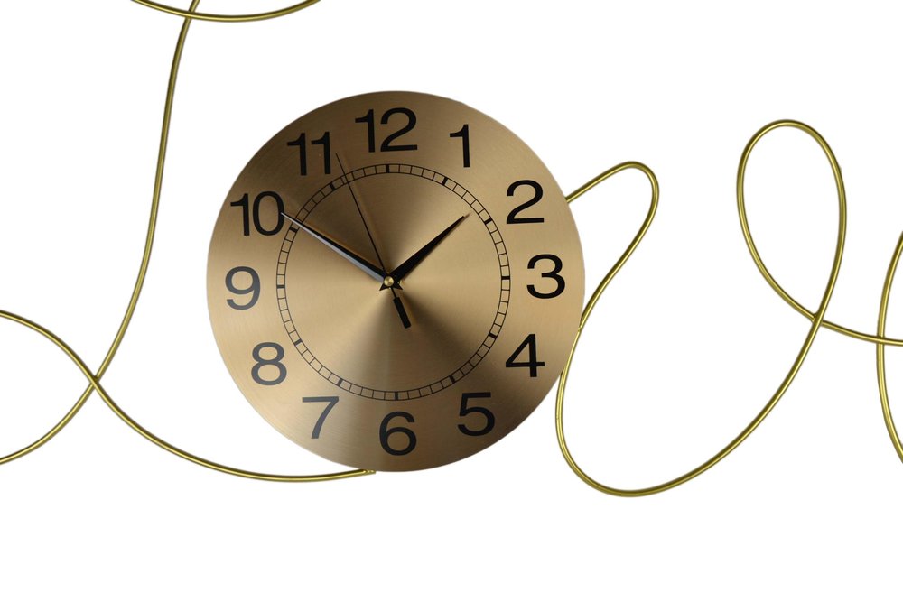 Gold clock with black numbers and hands on a white background
