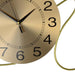 Gold clock with black numbers on a white background