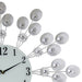 Decorative wall clock with floral design on a white background