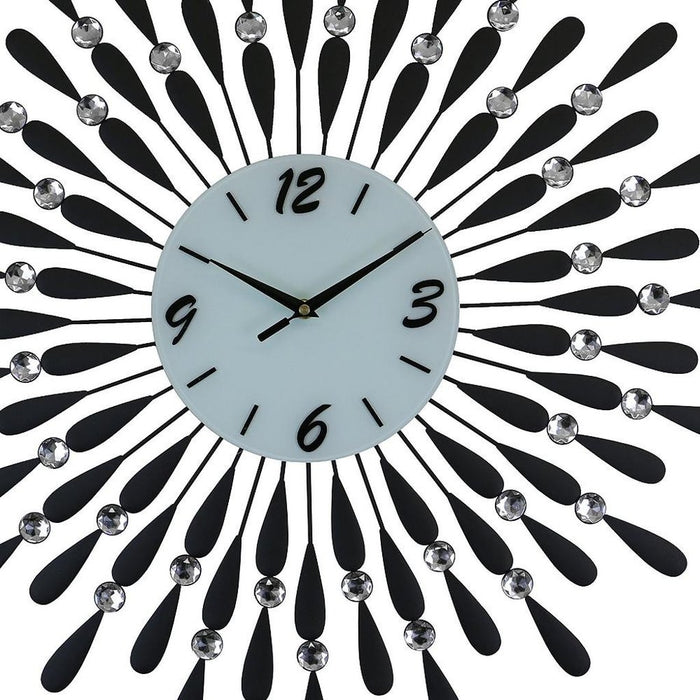 Decorative wall clock with black and silver design on a white background