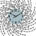 Decorative wall clock with a circular design of beads and wires on a white background