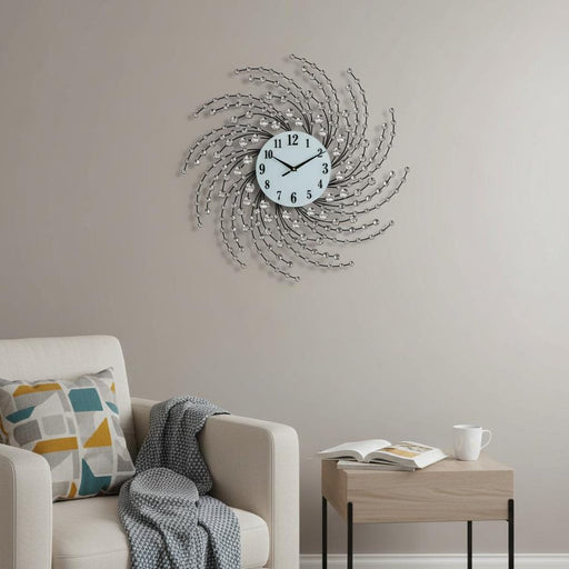 Decorative wall clock on a wall above a sofa with a side table.