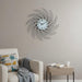 Decorative wall clock on a wall above a sofa with a side table.
