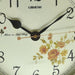 Close-up of a clock face with floral design and 'Lisheng' branding