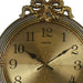 Decorative clock with gold face and ornate design on a white background