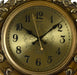 Gold ornate clock with black numbers and hands