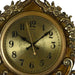 Decorative gold clock with intricate designs on a white background