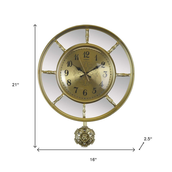 Gold wall clock with decorative pendulum, shown with dimensions on a white background