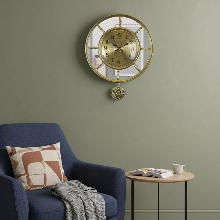 Decorative wall clock with a pendulum in a living room setting.