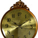 Decorative gold clock with intricate designs on a white background