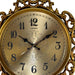 Decorative clock with gold frame and ornate design on a white background
