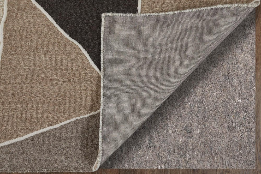 Close-up of a textured fabric with geometric pattern in brown, black, and gray.