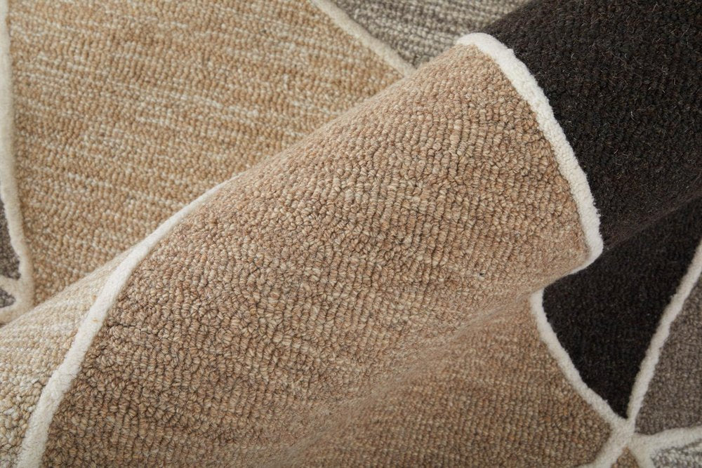 Close-up of a textured beige and brown rug with a geometric pattern.