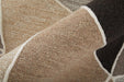 Close-up of a textured beige and brown rug with a geometric pattern.