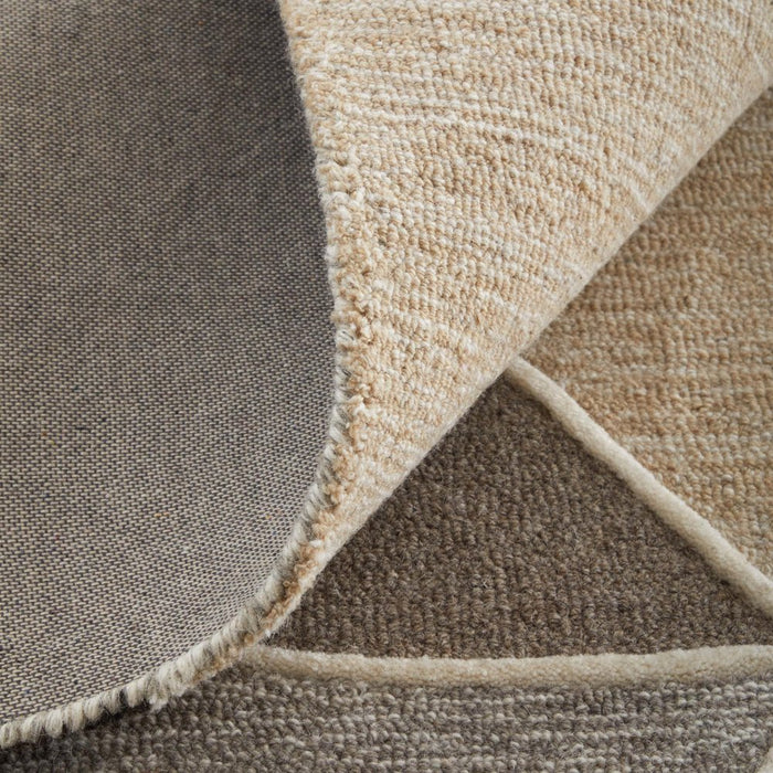 Close-up of a textured brown and beige rug corner