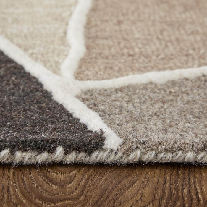 Close-up of a geometric patterned rug on a wooden floor
