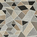 Geometric patterned rug with triangles in various shades of brown, gray, and black.