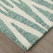Teal and white striped rug on a wooden floor
