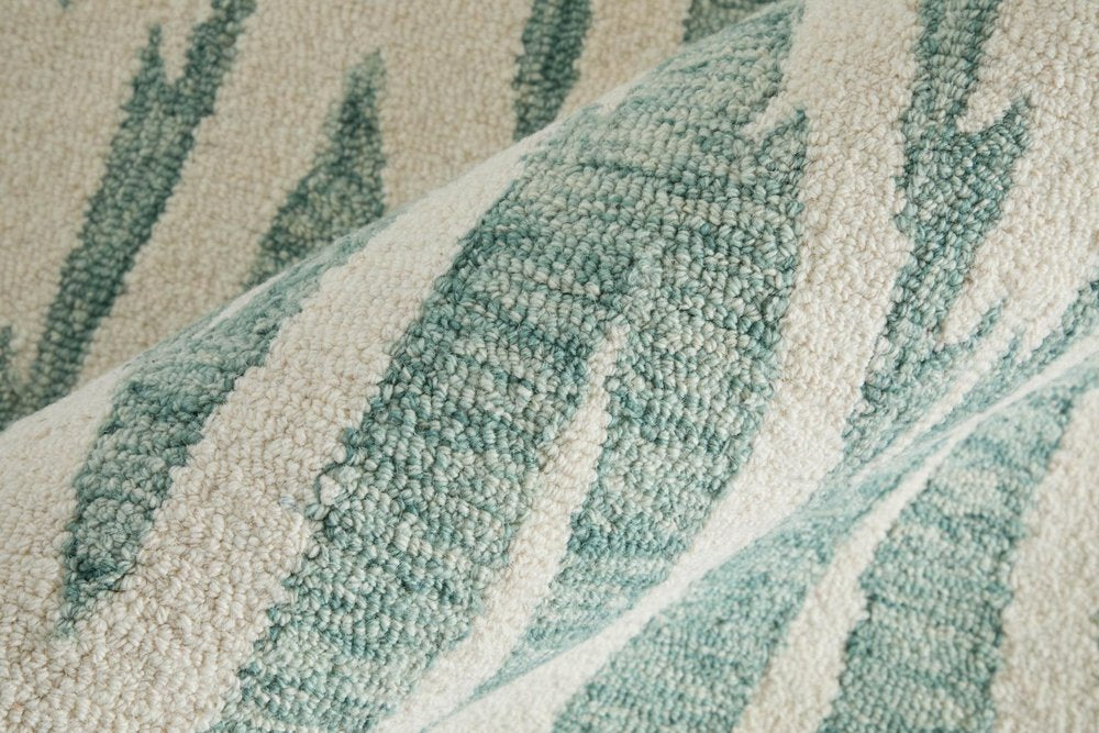 Close-up of a textured fabric with green and beige pattern