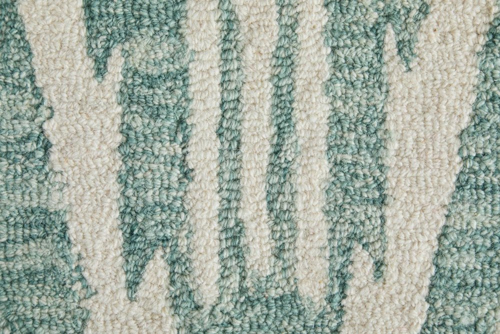 Close-up of textured teal and beige carpet