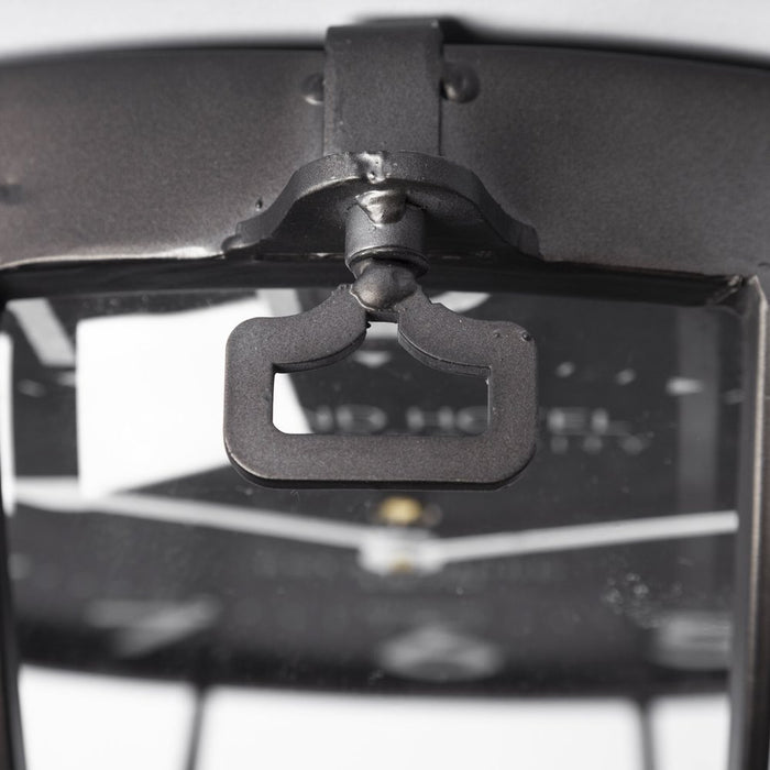 Close-up of a black metal bracket on a gray background