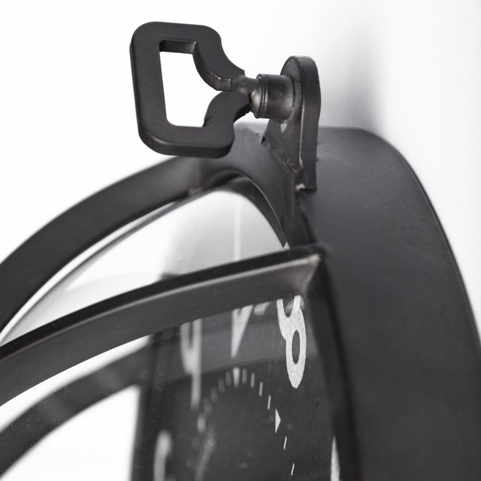 Close-up of a black clock with a unique design on a white background