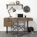 Home office setup with wooden desk, chair, lamp, and decor items.